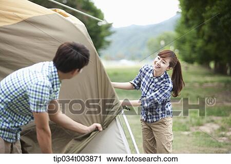 a couple building a tent View Large Photo Image Stock Image - a couple building a tent. Fotosearch