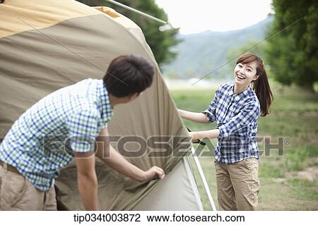 a couple building a tent View Large Photo Image Stock Image - a couple building a tent. Fotosearch