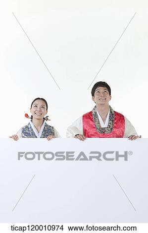 a couple in Hnabok holding an empty whiteboard View Large Photo Image Picture - a couple in Hnabok holding an empty whiteboard. Fotosearch
