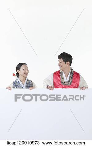 a couple in Hnabok holding an empty whiteboard View Large Photo Image Stock Image - a couple in Hnabok holding an empty whiteboard. Fotosearch