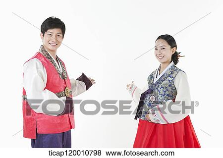 a couple introducing ways wearing Hanbok View Large Photo Image Stock Photo - a couple introducing ways wearing Hanbok . Fotosearch