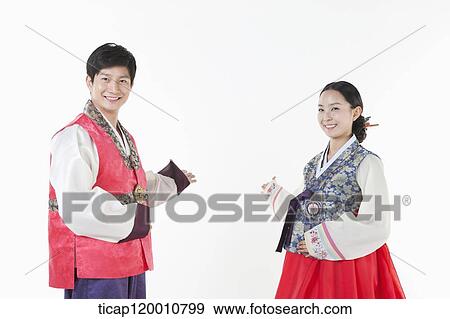 a couple introducing ways wearing Hanbok View Large Photo Image Stock Photo - a couple introducing ways wearing Hanbok . Fotosearch