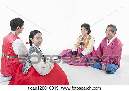a couple sitting in front of grandparents wearing Hanbok View Large Photo Image Stock Photo - a couple sitting in front of grandparents wearing Hanbok. Fotosearch