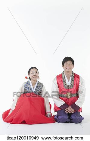 a couple sitting on the floor in Hanbok View Large Photo Image Stock Photo - a couple sitting on the floor in Hanbok. Fotosearch