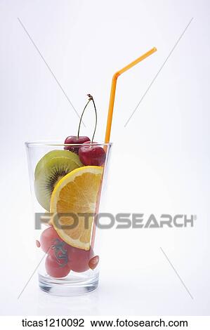 Stock Image - a cup filled with cut fruits . Fotosearch