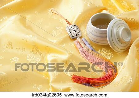 Stock Photography - a cup of tea on Korean silk with norigae. Fotosearch