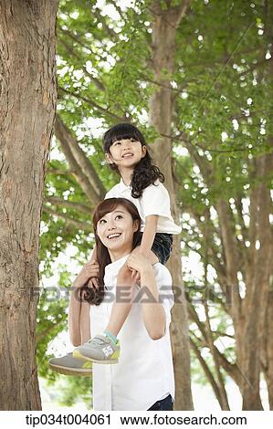 a daughter on mother's shoulders View Large Photo Image Stock Image - a daughter on mother's shoulders. Fotosearch