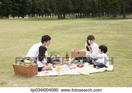 Stock Image - a family having a picnic meal. Fotosearch
