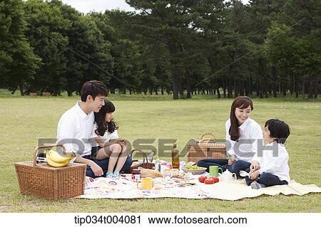Stock Image - a family having a picnic meal. Fotosearch