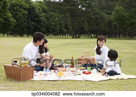 Stock Image - a family having a picnic meal. Fotosearch