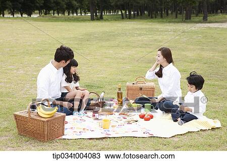 Stock Image - a family having a picnic meal. Fotosearch