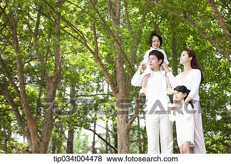 a family in a forest looking up View Large Photo Image Stock Photo - a family in a forest looking up. Fotosearch