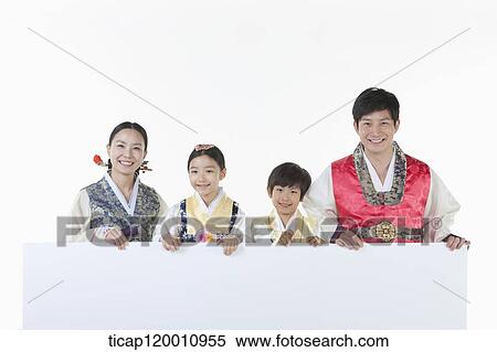 Stock Photography - a family in Hanbok holding an empty whiteboard. Fotosearch