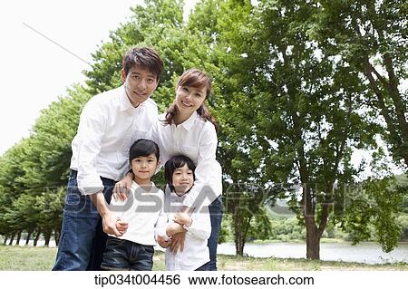 a family on grass View Large Photo Image Stock Photograph - a family on grass. Fotosearch