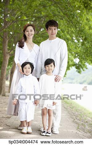 Picture - a family posing standing on a trail . Fotosearch