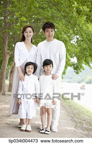 Stock Image - a family posing standing on a trail . Fotosearch