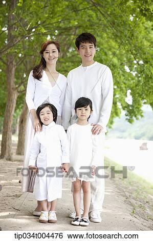 Stock Photograph - a family posing standing on a trail . Fotosearch