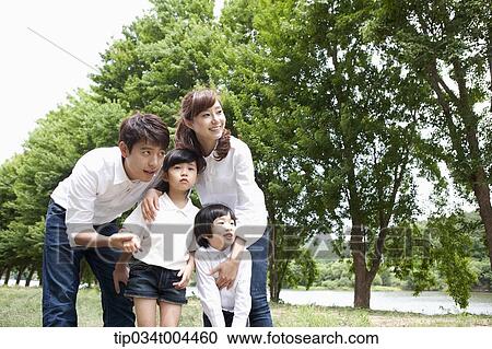 Stock Image - a family with kids posing. Fotosearch