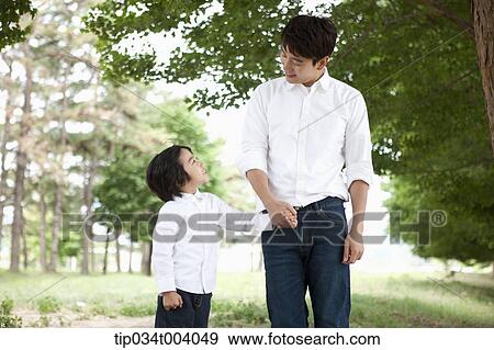 a father and a son taking a walk together View Large Photo Image Stock Photo - a father and a son taking a walk together . Fotosearch