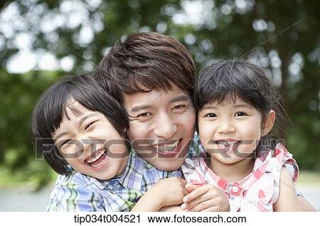 Stock Image - a father between kids . Fotosearch