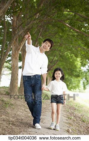 a father pointing somewhere while talking a walk with a daughter View Large Photo Image Stock Photograph - a father pointing somewhere while talking a walk with a daughter . Fotosearch