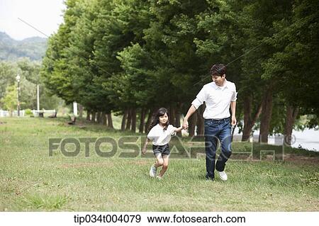 Stock Photo - a father running with a daughter. Fotosearch