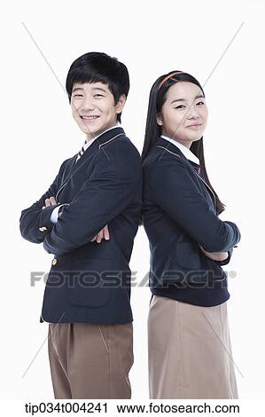 a female and a male student in school uniform posing with their backs together View Large Photo Image Stock Image - a female and a male student in school uniform posing with their backs together. Fotosearch