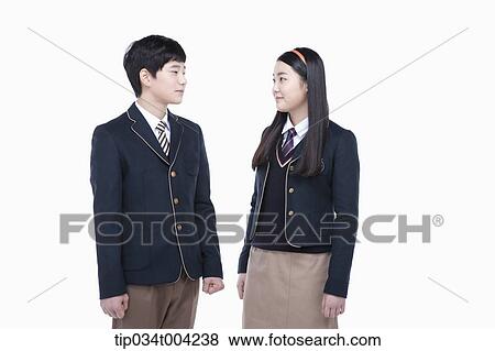 Stock Photo - a female and a male student with school uniform facing each other. Fotosearch