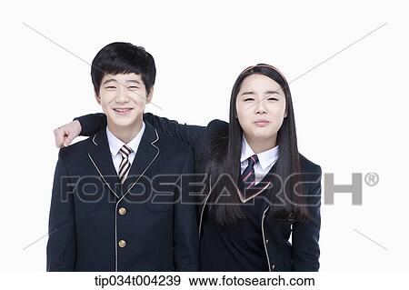 Stock Photo - a female and a male student with school uniform arms around each other. Fotosearch