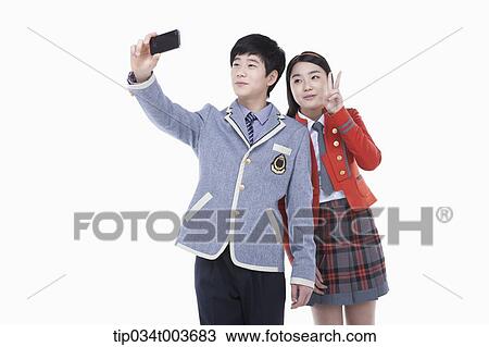 a female and male students taking a photo with a mobile phone View Large Photo Image Stock Image - a female and male students taking a photo with a mobile phone. Fotosearch
