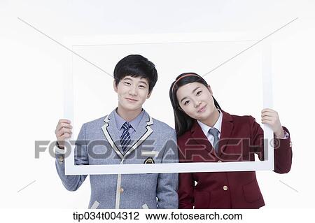 Stock Image - a female and male students with school uniform inside a white frame . Fotosearch