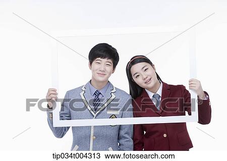 Stock Image - a female and male students with school uniform inside a white frame . Fotosearch
