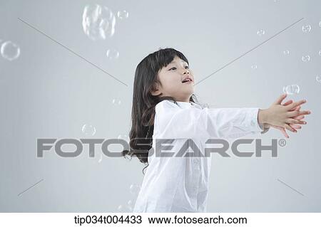 a female kid catching bubbles View Large Photo Image Stock Image - a female kid catching bubbles. Fotosearch