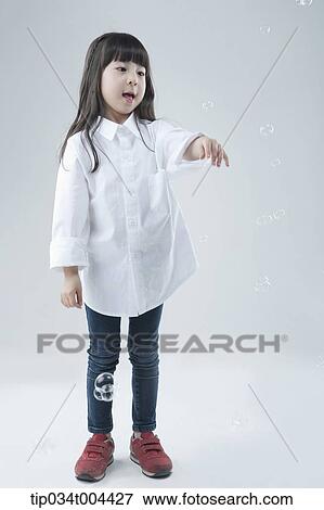 a female kid playing with bubbles View Large Photo Image Stock Photo - a female kid playing with bubbles. Fotosearch