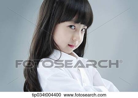 Stock Image - a female kid posing with arms crossed . Fotosearch