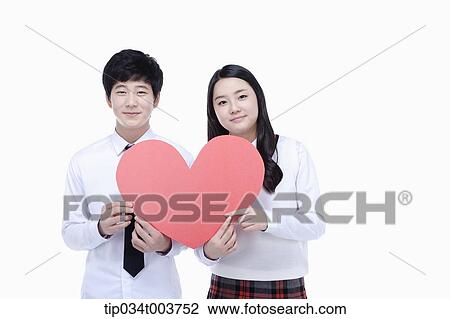 a female student and male student holding pink cushions View Large Photo Image Stock Image - a female student and male student holding pink cushions. Fotosearch