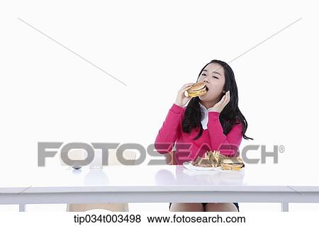 a female student in red sweater having a burger View Large Photo Image Stock Photo - a female student in red sweater having a burger. Fotosearch