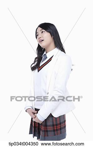 Stock Image - a female student in school uniform wearing a white jacket. Fotosearch