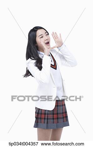 Stock Photo - a female student in school uniform wearing a white jacket with shouting pose . Fotosearch