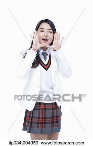 Stock Photo - a female student in school uniform wearing a white jacket with shouting pose . Fotosearch