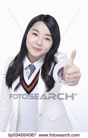 Stock Photo - a female student in school uniform showing thumbs up . Fotosearch