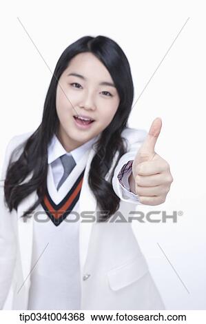 Stock Photo - a female student in school uniform showing thumbs up . Fotosearch