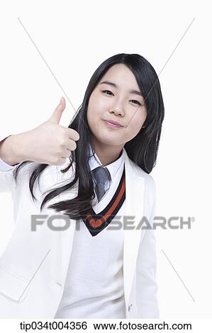 a female student in school uniform wearing a white jacket showing thumbs up View Large Photo Image Stock Photograph - a female student in school uniform wearing a white jacket showing thumbs up . Fotosearch