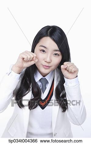 Stock Photograph - a female student in school uniform showing cute pose . Fotosearch