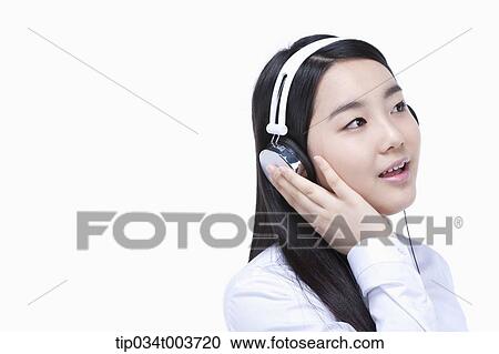 a female student listening on a headphone View Large Photo Image Stock Image - a female student listening on a headphone. Fotosearch
