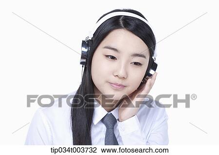 a female student listening on a headphone View Large Photo Image Stock Image - a female student listening on a headphone. Fotosearch
