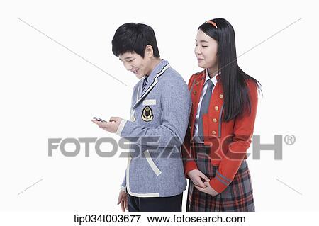 a female student looking at male student's Smartphone over his shoulders View Large Photo Image Stock Photo - a female student looking at male student's Smartphone over his shoulders. Fotosearch