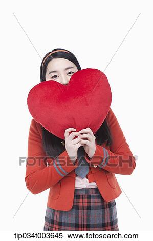 a female student posing with a red heart cushion View Large Photo Image Stock Photography - a female student posing with a red heart cushion. Fotosearch
