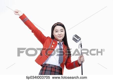 Stock Photography - a female student spreading her arm while grabbing microphone stand with the other hand . Fotosearch