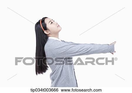 Stock Photograph - a female student stretching her neck and arms. Fotosearch